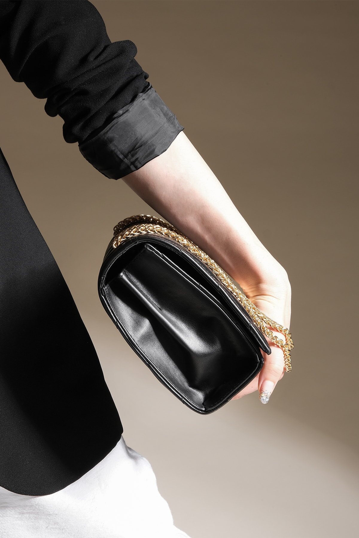 black shoulder bag with gold chain