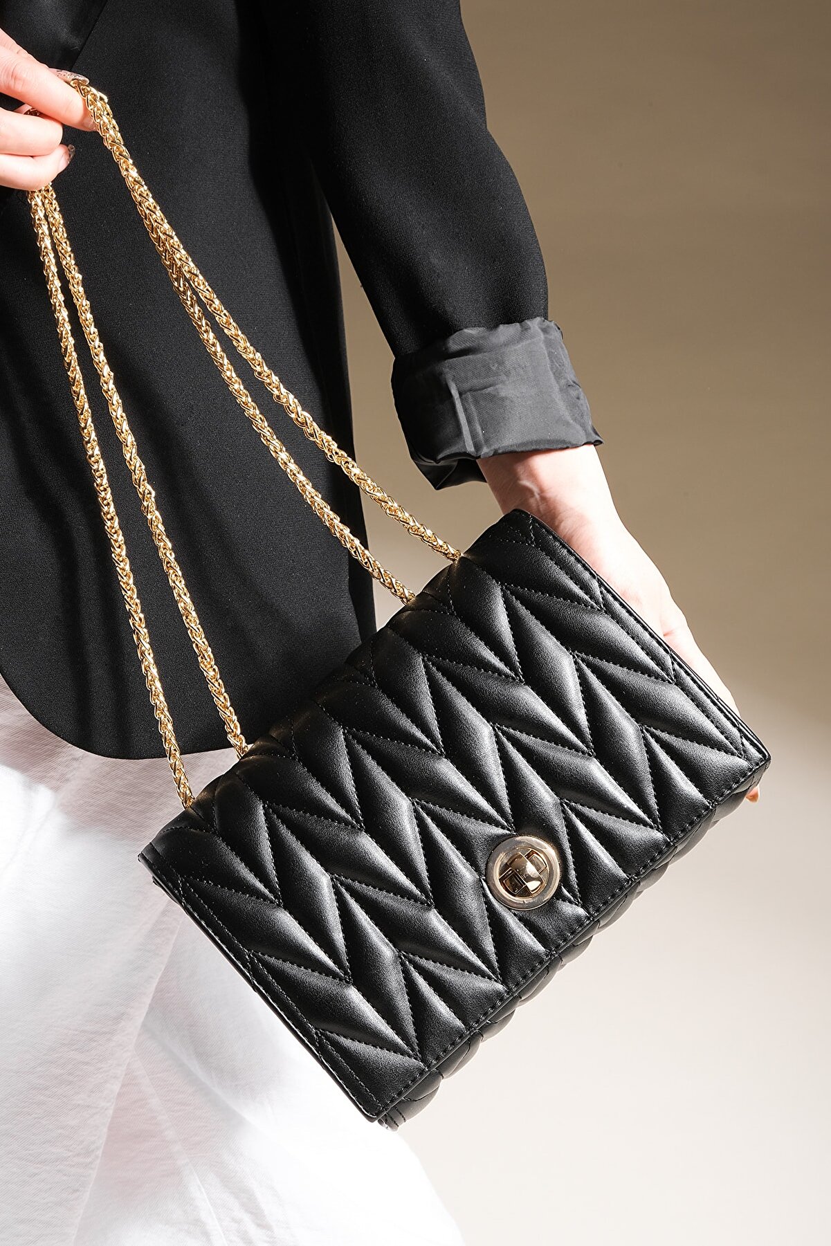 black shoulder bag with gold chain